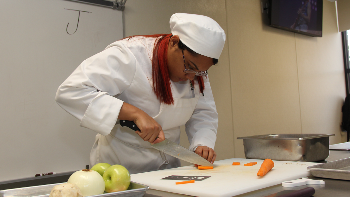 A culinary arts 快播成人 chops carrots in the 快播成人 MGM Culinary Arts Institute